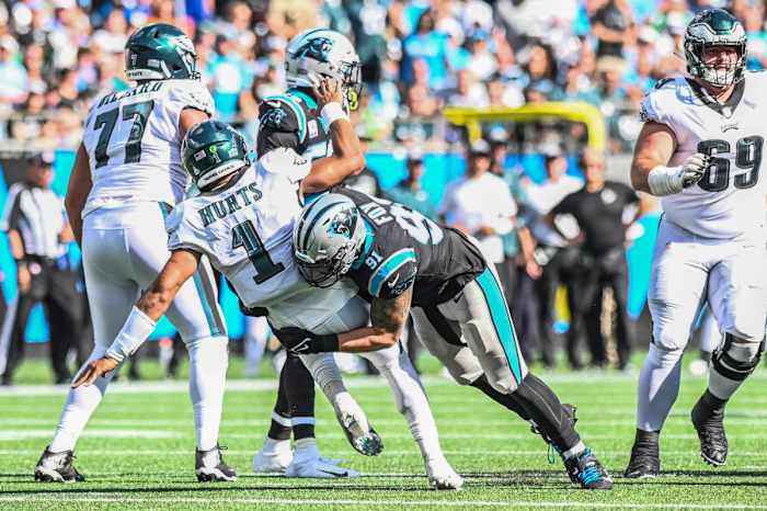 Oct 10, 2021; Charlotte, North Carolina, USA; Carolina Panthers defensive end Morgan Fox (91) sacks Philadelphia Eagles quarterback Jalen Hurts (1) during the second half at Bank of America Stadium. Mandatory Credit: Griffin Zetterberg-USA TODAY Sports